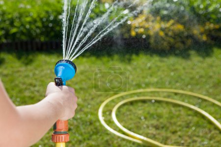Woman's hand with garden hose