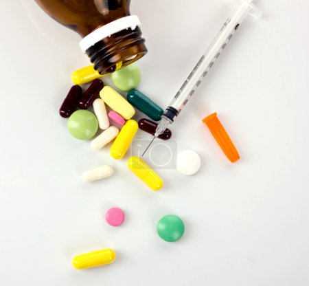 syringe and colorful drugs