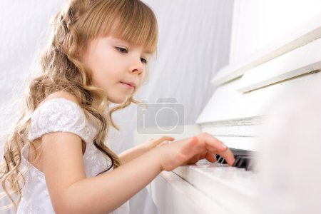 girl playing on piano
