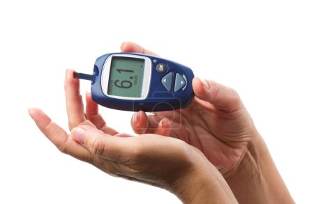 womans hand and glucometer