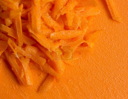  carrot on orange carving board  