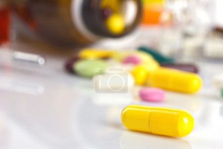 yellow capsule and different medicaments 