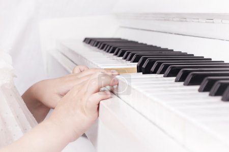 baby playing on piano