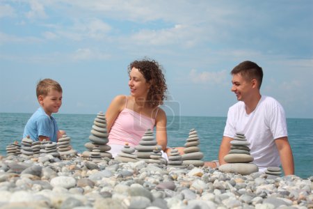 Family and stone stacks on pebble beach