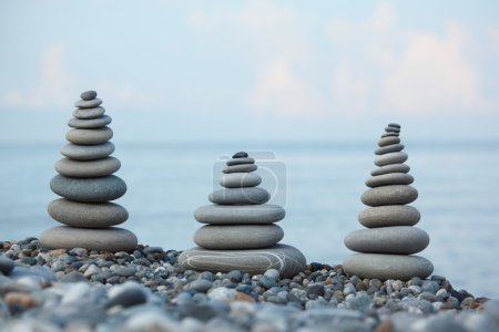 Three stone stacks on pebble beach