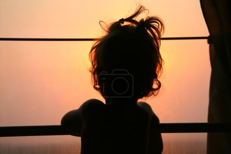 Silhouette of child in window of train