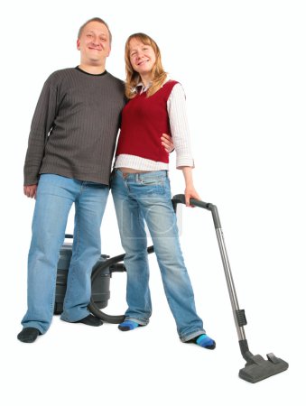 Man embraces woman with vacuum cleaner