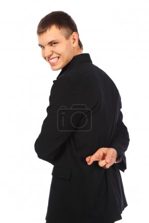 Smiling businessman with fingers crossed behind his back