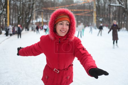 Young woman on skating rink in park