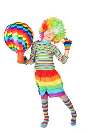Boy in clown dress with multicolored hot-air balloon standing is