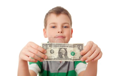 Smiling boy holds one dollar in both hands isolated on white ba