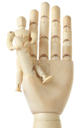 Wooden figure of little man sitting on big hand, front view, iso