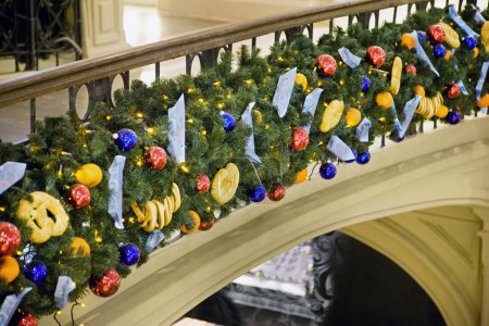 Christmas ornaments attached to handrail in shopping centre