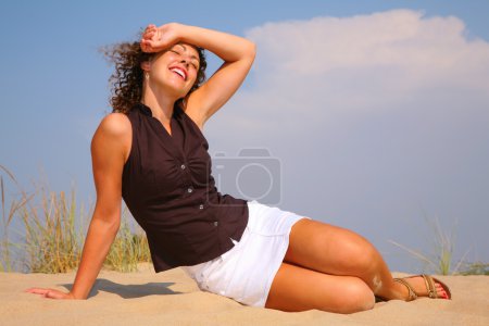 Young beuty woman sit on sand