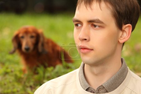 Young man with dachshund outdoor