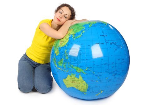Young beauty woman sitting near big inflatable globe with closed