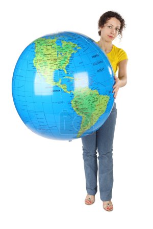 Young curl woman in yellow shirt holding big globe and looking a