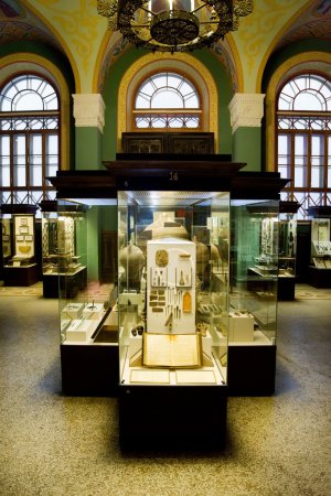 Museum exhibits of ancient relics in glass cases against big win