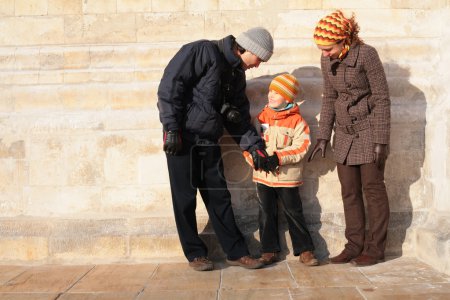 Family against a stone wall
