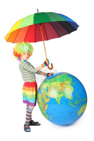Boy in clown dress with umbrella and big globe isolated on white