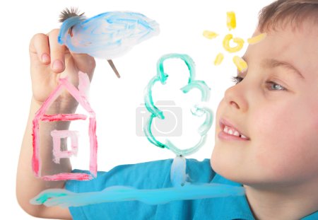Boy paints on glass cloud and house