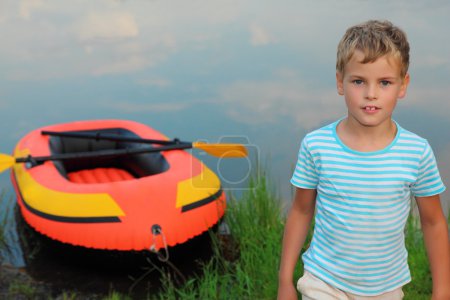 Boy and inflatable boat ashore