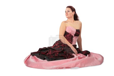 Sitting beautiful woman in luxurious dress