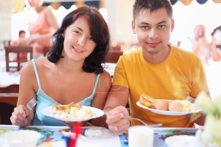 Married couple having breakfast at restaurant, Have control over