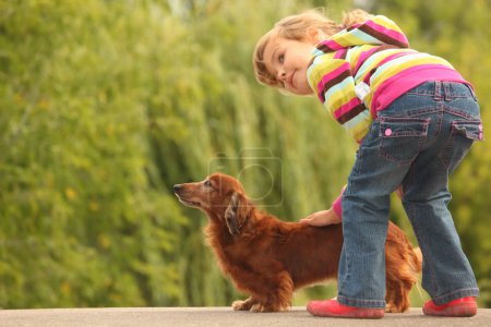 Little girl and her dachshund