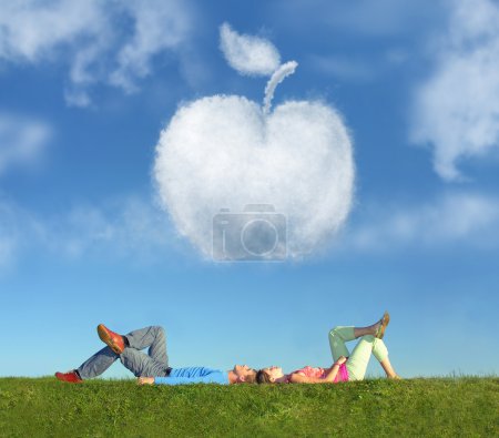 Lying couple on grass and dream apple collage