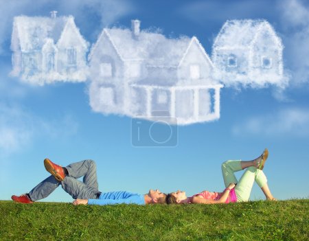 Lying couple on grass and dream three cloud houses collage