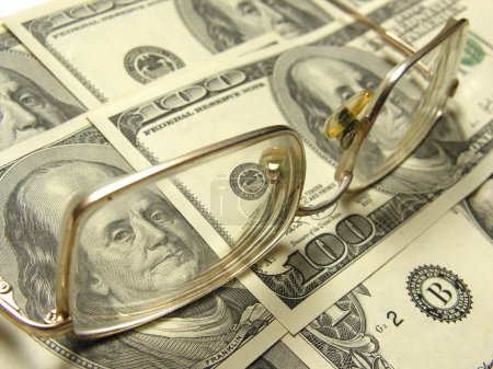 Close-up of dollars and eyeglasses