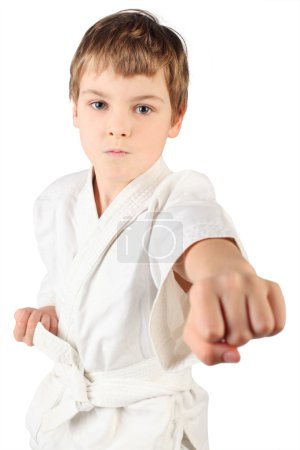 Karateka boy in white kimono fighting isolated on white backgrou
