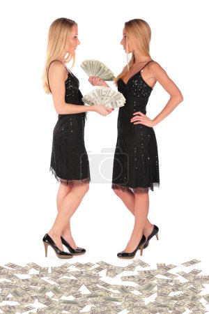 Twin girls holding Dollars