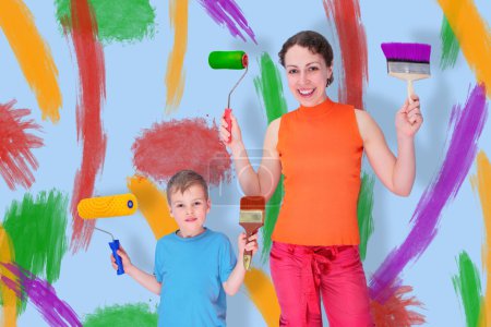 Son and mother draw with rollers and brushes on a wall, collage