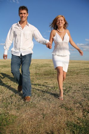 Running couple on meadow
