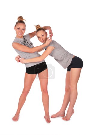 Twin sport girls encirlce each other by hands