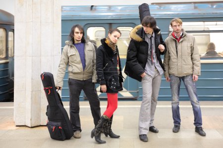 Four young musicians at metro station