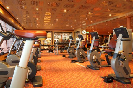 Large gym hall with running tracks, exercise bicycle and dumbbel