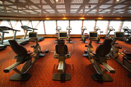 Large gym hall with exercise bicycle in cruise ship view from ba