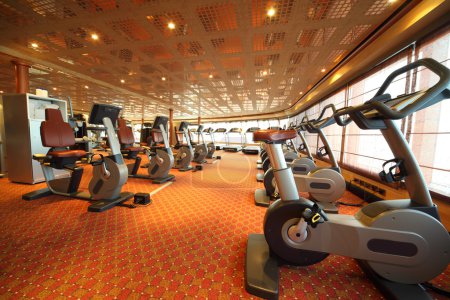 Large gym hall with exercise bicycle in cruise ship general view