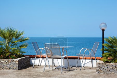 Table and chairs on beach