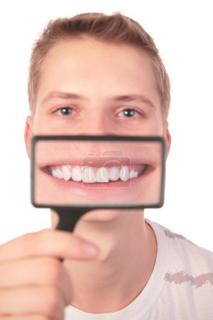 Man shows smile through magnifier