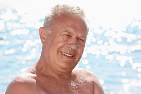 Portrait of elderly smiling man on seacoast