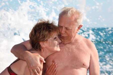 Portrait of aged pair in sea surf