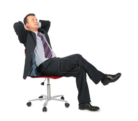 Dreaming businessman sits on office chair