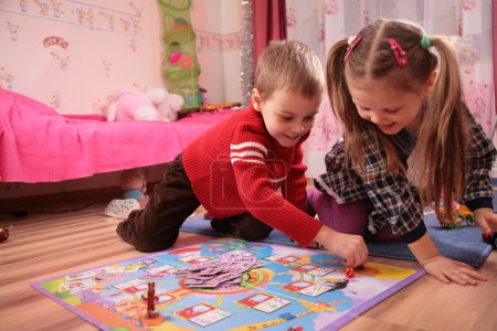 Two children play in playroom