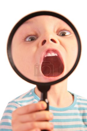 Child with open mouth through magnifier