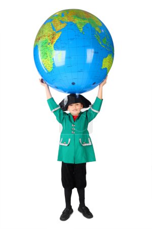 Little boy in historical dress holding big inflatable globe over