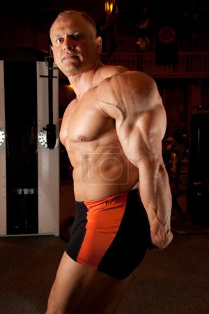 Bodybuilder demonstrates his muscles